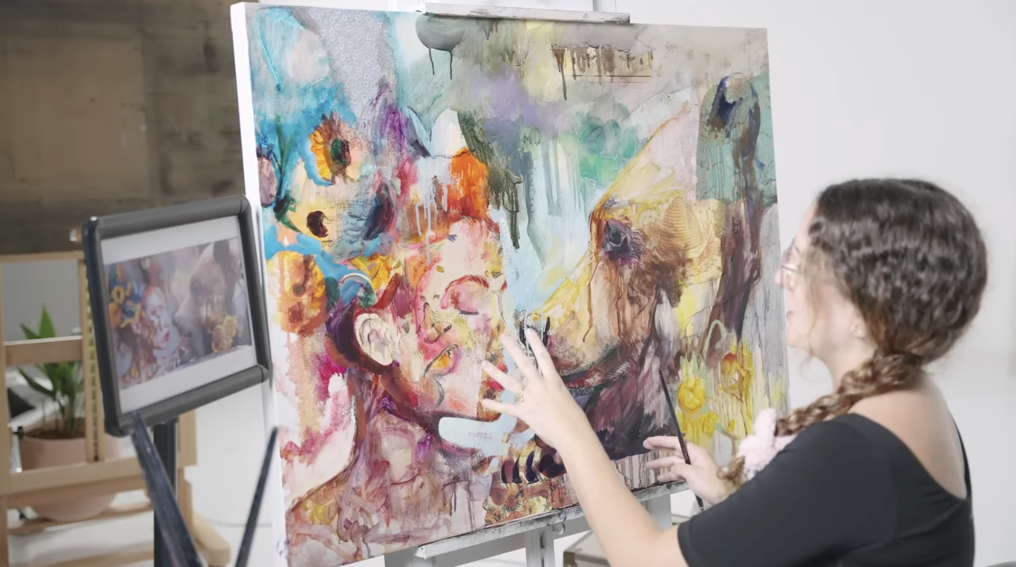 Woman working on unfinished painting
