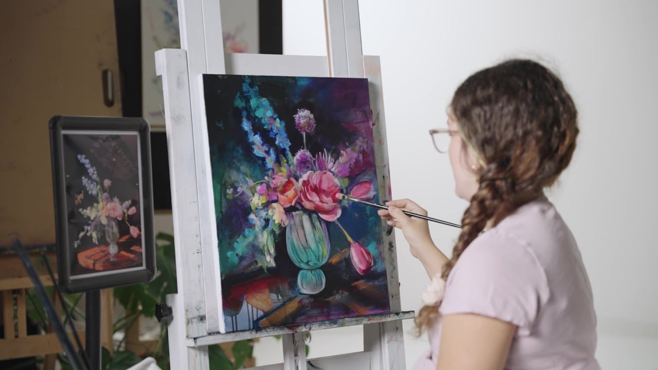 Girl painting a vase of flowers pink