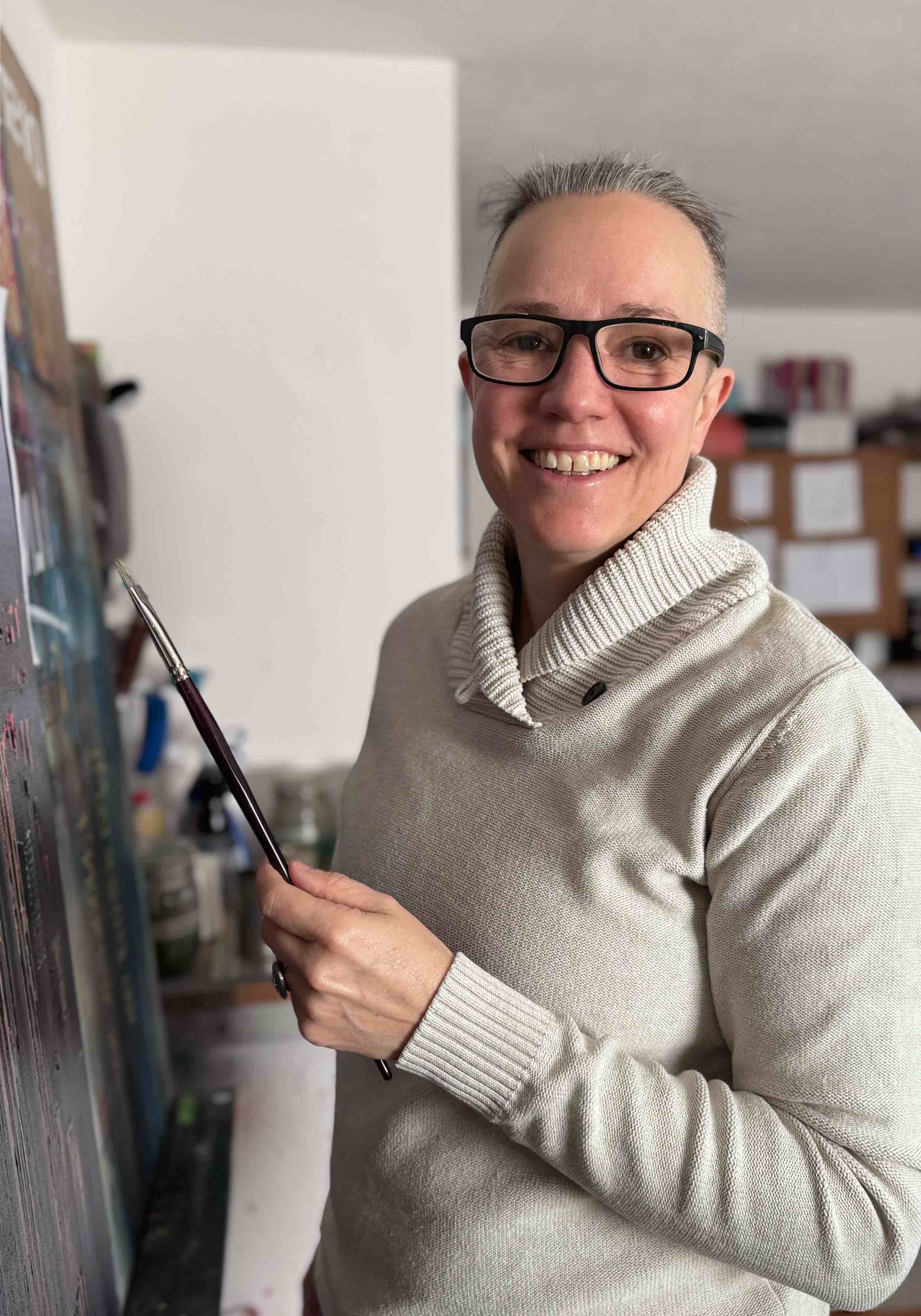 person painting at easel