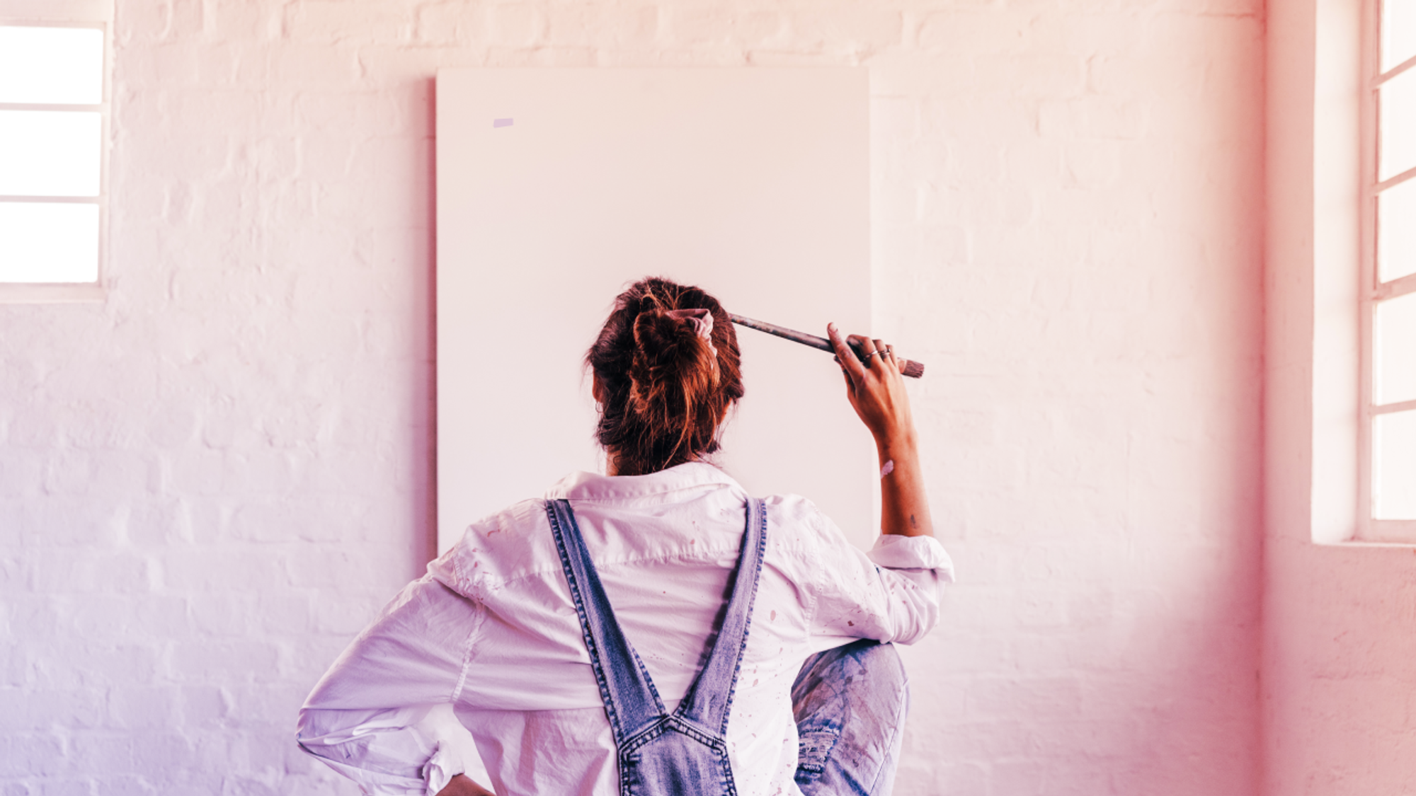 Woman standing in front of blank canvas