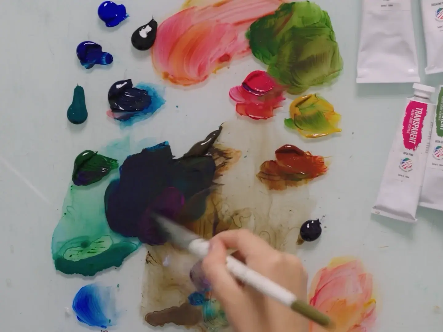 A palette of mixed acrylic colors beside paint tubes and brushes, from lesson 6