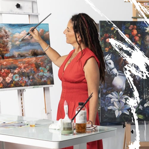 Woman in red dress holding paintbrsh to canvas landscape